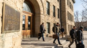people carrying briefcases exiting Courthouse Montana stone building entrance